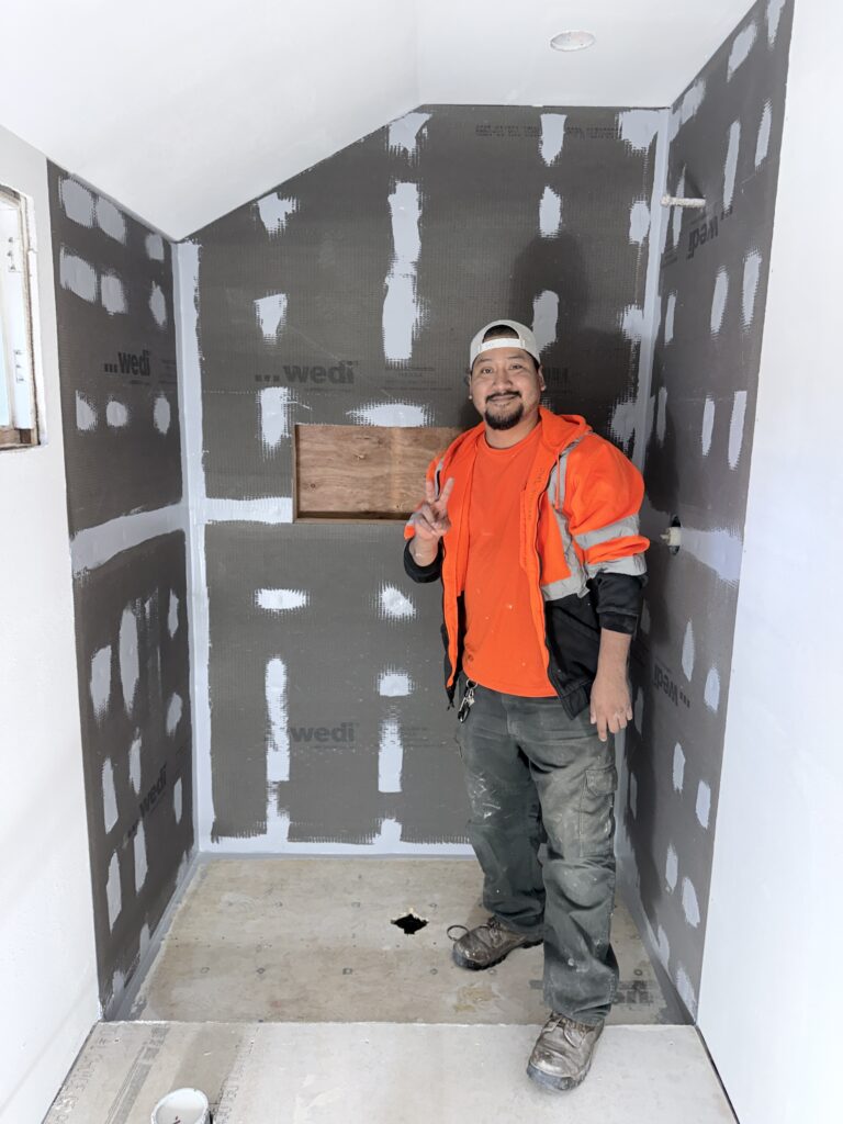 Image_20251120_153126_285 picture of joel standing in front of a bathroom tile project in progress
